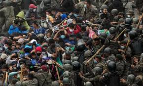 Migrant caravan trekking north to US border clashes with Guatemalan troops  | Refugees | The Guardian
